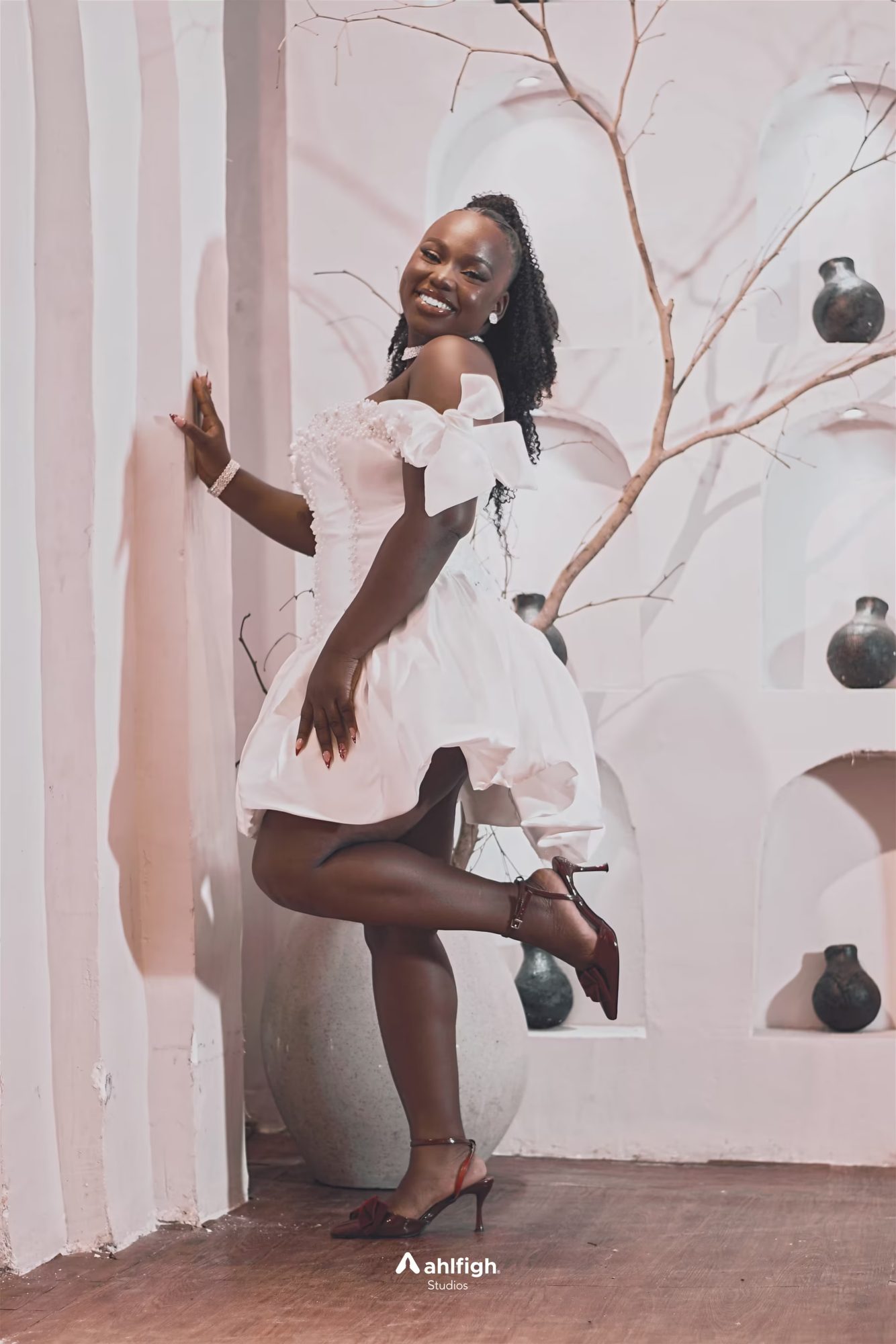 Model in a white dress among arches