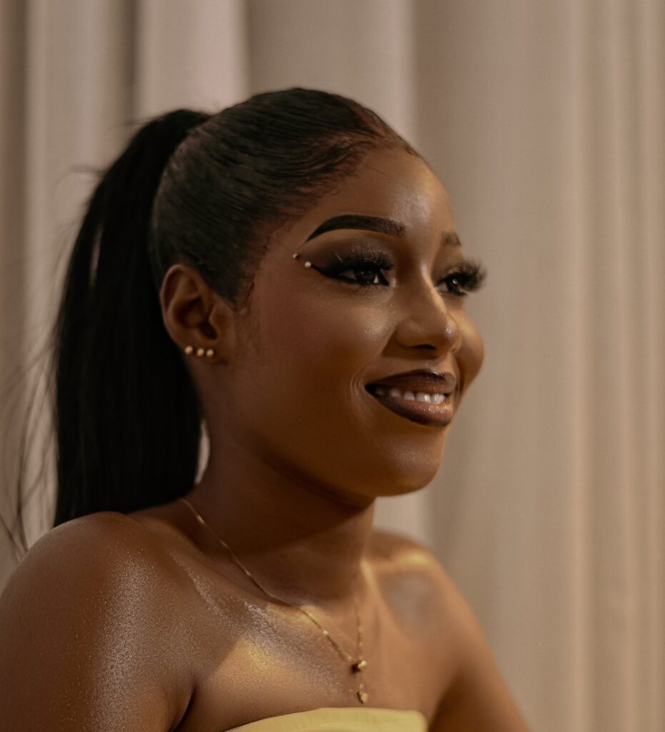 Nikki in a cream strapless dress, smiling