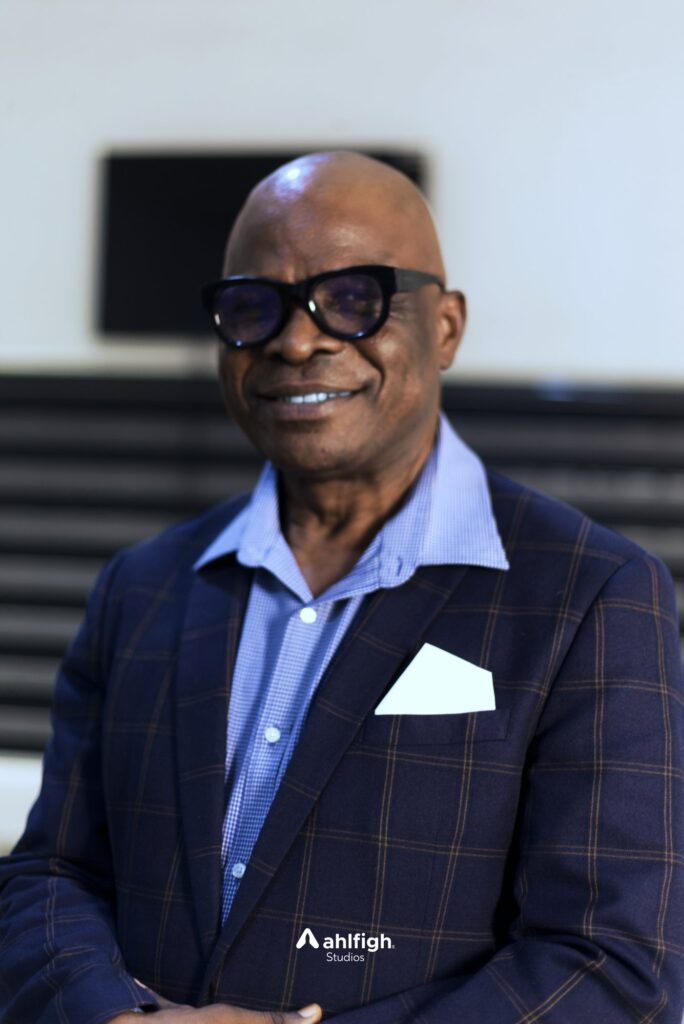 Carlos staff portrait: a senior colleague in glasses and a checked blazer